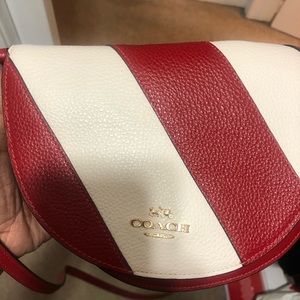 Red and white Coach crossbody bag.